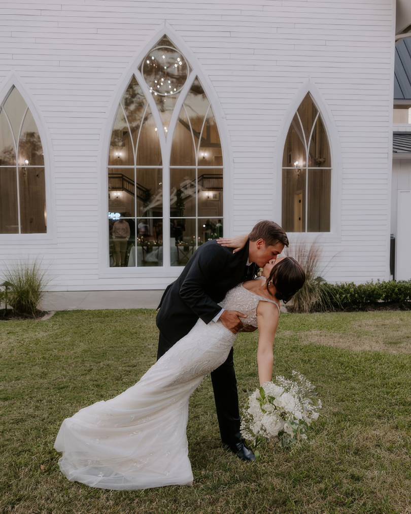 bride and groom dip in suit and bride's justin alexander wedding dress, evelyn.