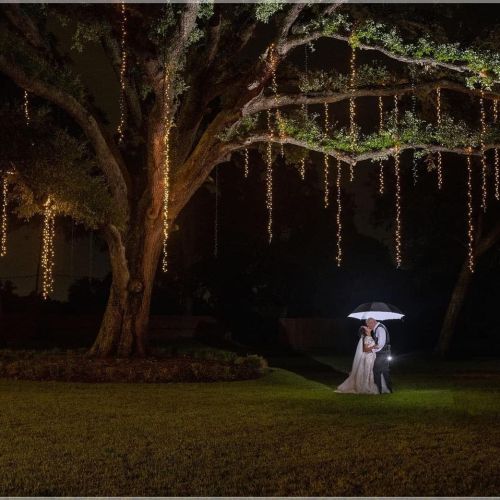 Bella Moon Barn Event Venue with giant oak tree and lights with couple under the dark sky